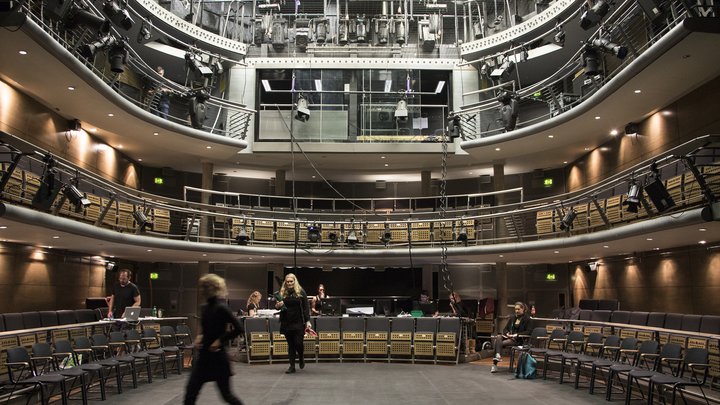 the Jerwood Vanbrugh Theatre with house lights on and students working